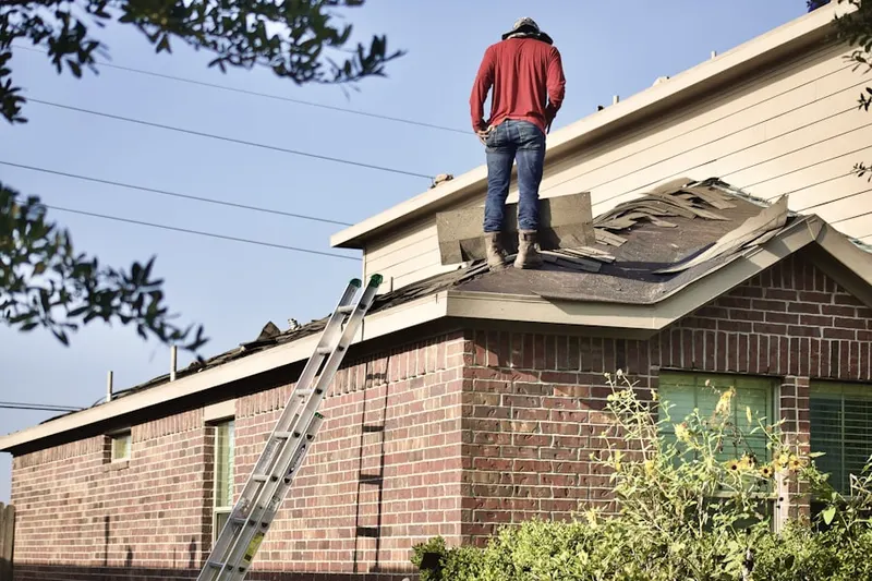 Professional roofer working on a residential roof in Sonora Sunrise